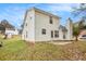 Side view of a house with white siding, a patio, and a chimney at 4103 Kingship Dr, Ellenwood, GA 30294