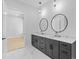 Double vanity bathroom with marble countertops and large mirrors at 555 Versailles Dr, Auburn, GA 30011