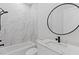 Modern bathroom with marble tile and floating vanity at 555 Versailles Dr, Auburn, GA 30011