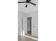 Light-filled bedroom with hardwood floors and access to hallway at 555 Versailles Dr, Auburn, GA 30011