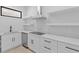 White kitchen cabinets and quartz countertops with floating shelves at 555 Versailles Dr, Auburn, GA 30011