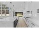Modern kitchen with white cabinets, marble countertops and a large island at 555 Versailles Dr, Auburn, GA 30011