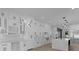 Modern kitchen with white cabinets, marble countertops, and wine rack at 555 Versailles Dr, Auburn, GA 30011