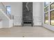 Modern living room with floor to ceiling fireplace and large windows at 555 Versailles Dr, Auburn, GA 30011