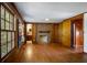 Finished basement with hardwood floors, brick fireplace, and built-in shelving at 3766 Citation Dr, Decatur, GA 30034