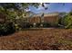 Brick house with deck and patio, surrounded by fall leaves at 3766 Citation Dr, Decatur, GA 30034