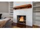 Cozy living room featuring a brick fireplace with a wood mantel and built-in shelving at 3766 Citation Dr, Decatur, GA 30034