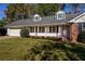 Ranch-style home with a brick facade, attached garage, and a well-manicured lawn at 3766 Citation Dr, Decatur, GA 30034