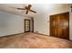 Simple bedroom with wood door and neutral carpeting at 2647 Club Forest, Conyers, GA 30013