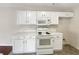 Kitchen with white cabinets, microwave, and electric range at 3781 Harvest Dr, Decatur, GA 30034