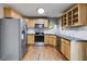 Modern kitchen with stainless steel appliances, oak cabinets, and tile backsplash at 364 Whooping Creek Rd, Carrollton, GA 30116