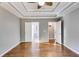 Main bedroom with tray ceiling, wood floors, and access to bathroom and closet at 364 Whooping Creek Rd, Carrollton, GA 30116