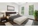 Virtually staged bedroom with hardwood floors and large windows at 53 Honour Nw Ave, Atlanta, GA 30305