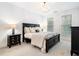 Main bedroom with king bed, chandelier, and window views at 53 Honour Nw Ave, Atlanta, GA 30305