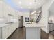 Modern kitchen with white cabinets, a large island, and hardwood floors at 53 Honour Nw Ave, Atlanta, GA 30305