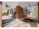 Inviting front porch with brick columns, ceiling fan, and seating area at 1841 Thompson Ave, Atlanta, GA 30344