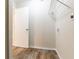 Small laundry room with wood-look flooring and shelving at 3851 Bonnie Se Ln, Atlanta, GA 30354