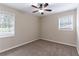 Spacious bedroom featuring neutral walls, ceiling fan and two windows at 3851 Bonnie Se Ln, Atlanta, GA 30354