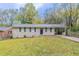 Brick ranch house with a driveway and landscaped yard at 3851 Bonnie Se Ln, Atlanta, GA 30354