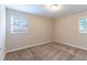 Spacious bedroom with neutral walls, carpet, and two windows at 3851 Bonnie Se Ln, Atlanta, GA 30354