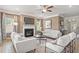 Living room with hardwood floors, fireplace, and large windows with curtains at 277 Silver Leaf Trl, Douglasville, GA 30134