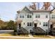 Attractive townhome with gray and white siding, dark brown stairs, and landscaping at 3829 Oxford Cir, Doraville, GA 30340