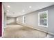 Spacious finished basement with large windows and gray walls at 2527 Sky Valley Dr, Dacula, GA 30019