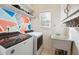 Laundry room with washer, dryer, sink, and colorful accent wall at 2527 Sky Valley Dr, Dacula, GA 30019