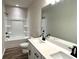 Bathroom boasts double sinks, a shower/tub combo, and modern fixtures at 1883 Westfall Landing, Auburn, GA 30011