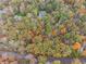 Property situated in a wooded area with fall foliage at 220 Spring Branch Dr, Canton, GA 30115