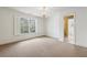 Bedroom with large window, chandelier, and access to bathroom at 220 Spring Branch Dr, Canton, GA 30115