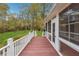 Red deck with white railing overlooking a grassy backyard at 220 Spring Branch Dr, Canton, GA 30115