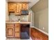 Small kitchenette with wood cabinets, microwave, and mini-fridge at 220 Spring Branch Dr, Canton, GA 30115