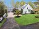 Aerial view of a two-story white house with a large yard and driveway at 220 Spring Branch Dr, Canton, GA 30115