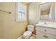 Clean bathroom with white vanity, toilet, and window at 220 Spring Branch Dr, Canton, GA 30115