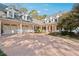 Two-story home with a three-car garage and red front door at 220 Spring Branch Dr, Canton, GA 30115