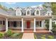 Elegant home with a red door and a spacious covered porch at 220 Spring Branch Dr, Canton, GA 30115