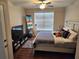 Bedroom with a king-size bed, TV, and large window with blinds at 4805 West Village Way # 3207, Smyrna, GA 30080