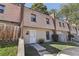 Two-story townhouse with wood shake roof and a well-maintained lawn at 6429 Woodstone Way, Morrow, GA 30260