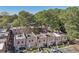 Aerial view of a row of townhouses in a wooded area at 6429 Woodstone Way, Morrow, GA 30260