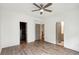 Main bedroom with hardwood floors, ceiling fan, and access to walk-in closet and bathroom at 1225 Chelsea Nw Cir, Atlanta, GA 30318