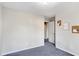 Bedroom with window, carpet, and door to hallway at 3337 Camens Way, Buford, GA 30519