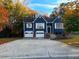 Blue house with white accents, two-car garage, and landscaping at 3337 Camens Way, Buford, GA 30519