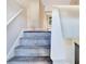 Gray carpeted staircase leading to the second floor at 3337 Camens Way, Buford, GA 30519