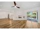 Open living room with hardwood floors, white fireplace, and ceiling fan at 513 Duke Dr, Marietta, GA 30066