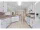 Galley kitchen with white cabinets and tile flooring at 124 Dodgen Rd, Hampton, GA 30228