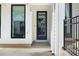 Townhouse entrance with a dark door and a view of neighboring house at 124 Pearl St, Woodstock, GA 30188