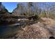 Creek with a rocky bottom, flowing through a wooded area at 1765 Holly Springs Ne Rd, Marietta, GA 30062