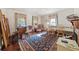 Spacious living room featuring hardwood floors, large windows, and a grand piano at 1765 Holly Springs Ne Rd, Marietta, GA 30062
