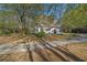 View of the home's side, showcasing landscaping and driveway at 1765 Holly Springs Ne Rd, Marietta, GA 30062